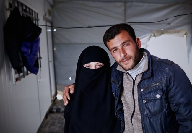 Syrian refugees Amaneh Abdel Hamid Al Nasser, 16, and Ahmad Jamal Abo Sallo'o, 23, pose for a photograph in Zaatari refugee camp located 10 km east of Mafraq, Jordan. They married last year in a ceremony that they both call the best day of their lives. (Photo by Shawn Baldwin/UNHCR)