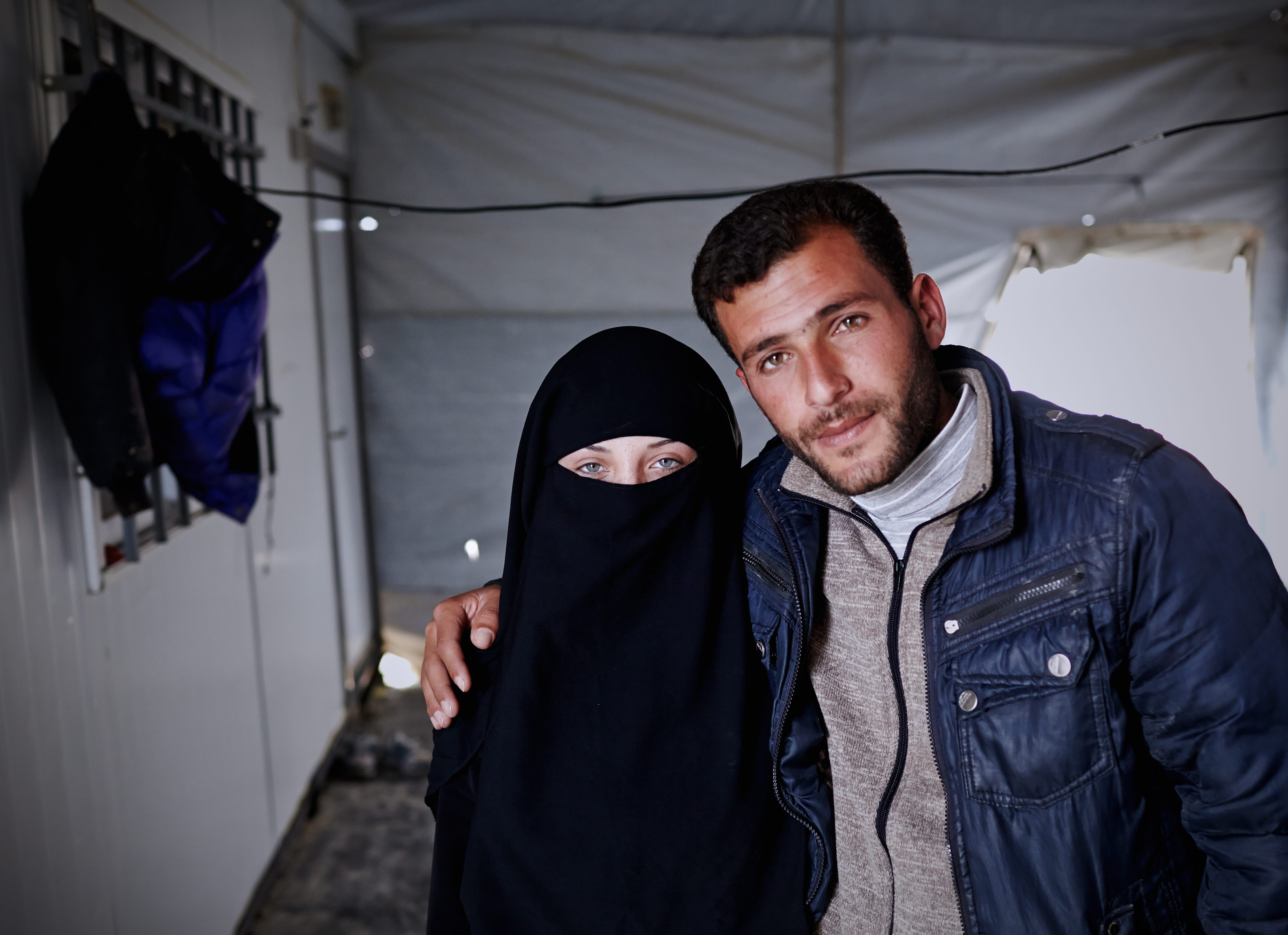 Syrian refugees Amaneh Abdel Hamid Al Nasser, 16, and Ahmad Jamal Abo Sallo'o, 23, pose for a photograph in Zaatari refugee camp located 10 km east of Mafraq, Jordan. They married last year in a ceremony that they both call the best day of their lives. (Photo by Shawn Baldwin/UNHCR)