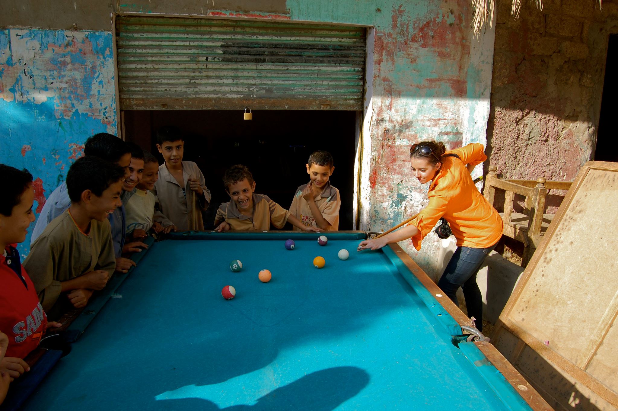 Playing pool with a group of Egyptian children in the countryside.