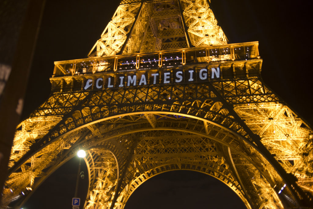 The "Climate Sign" appears on the Eiffel Tower on the night of December 6, 2015. (Camilla Andersen/GroundTruth)