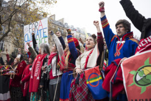 Environmental advocates protest for climate justice in front of the Arc de Triomphe in Paris, France on December 12, 2015. 