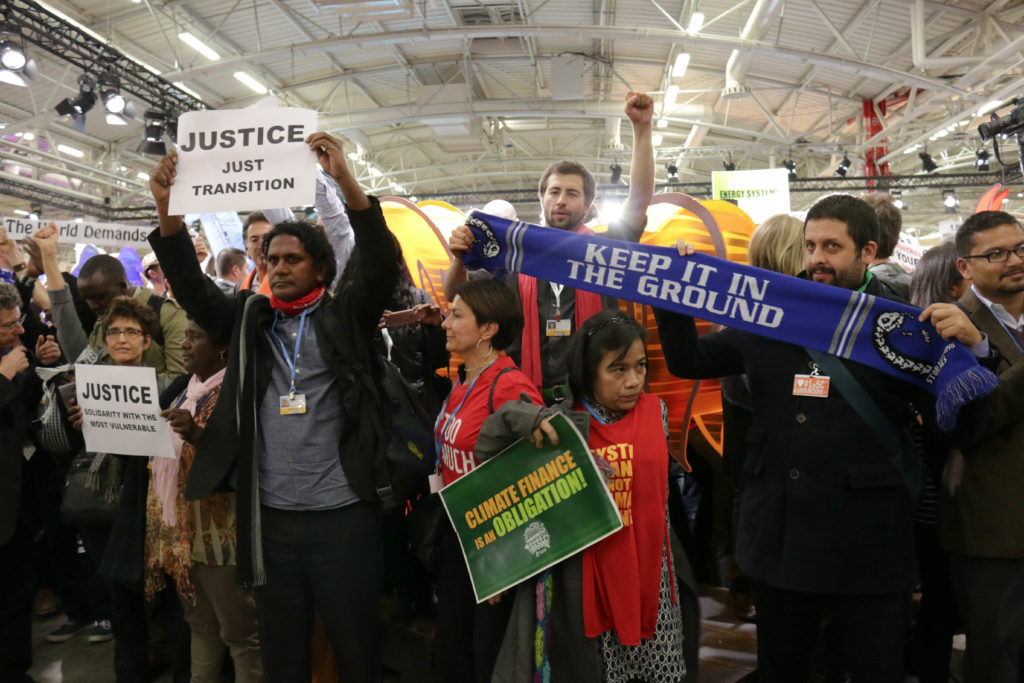 Climate advocates for youth, women, developing countries and small island nations protest the draft agreement released today. (Photo by Justine Calma/GroundTruth)