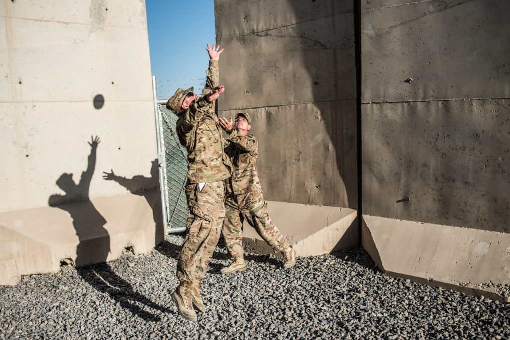 US public affairs soldiers play football within the small, fenced-in compound where reporters are billeted at Kandahar Airfield. In 2013, reporters were not allowed to leave the billets without a military escort - before that they were given the run of the airfield. (Photo by Ben Brody)