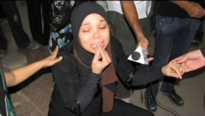 Essam Atta's sister, Hanan, grieves outside Zeinhom Morgue in Cairo, Friday, October 29, 2011. 