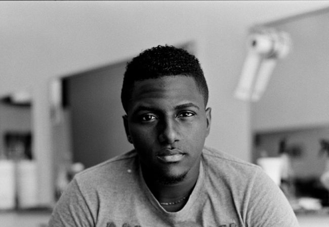 Alberto Ramon, 20, came to Puerto Rico from the Dominican Republic to join his father and found work as a barber. He plans to move to the United States as soon as he gets the opportunity. "It's better to go somewhere else than here," he says. "There's nothing. If customers used to come weekly, now they come monthly...Hopefully this year, God willing, I am going to the U.S." (Edwin Torres/GroundTruth)