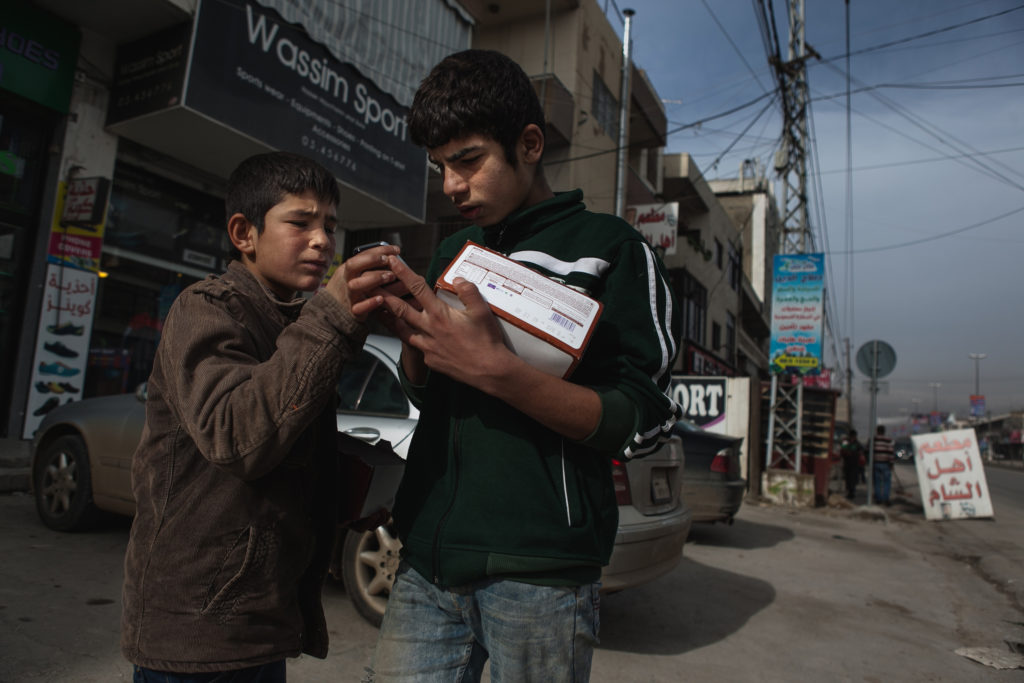 With no other way to make money, Syrian children from the Bar Elias refugee camp in Lebanon sell candy in the street.  (Photo by Christopher Lee/GroundTruth)