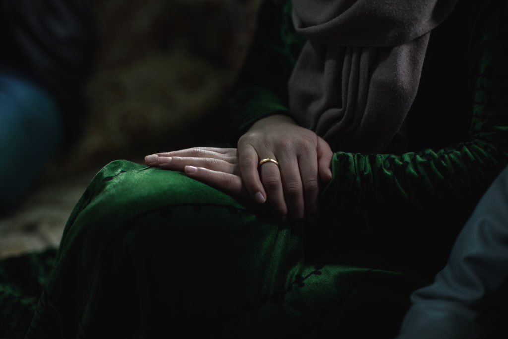 Batoul, 15, sat in her parents' informal tented settlement. Batoul, a Syrian refugee, was married off by her parents at the age of 13 as a way of combating the unsolicited harassment and threats she received from local men. While there are over an estimated one million Syrian refugees in Lebanon, the local laws prohibit many rights and opportunities for those that seek refuge from fighting in Syria. Many parents are forced to marry off their daughters, usually for both economic and safety reasons. (Photo by Christopher Lee/GroundTruth)