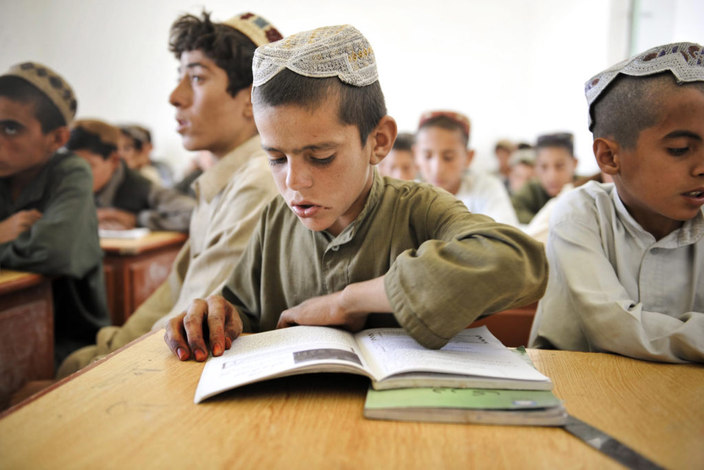 A boy attends class at a school in Nad e Ali, Helmand Province, Afghanistan. (Photo via ResoluteSupportMedia/Flickr) 