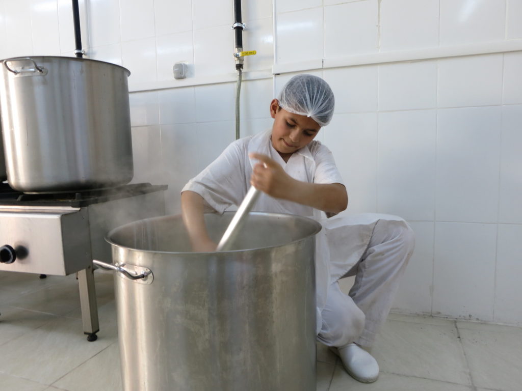 Rubi stirs milk for ishta