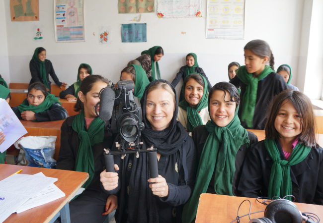 GroundTruth Films Director Beth Murphy poses with a classroom of students in Afghanistan.
