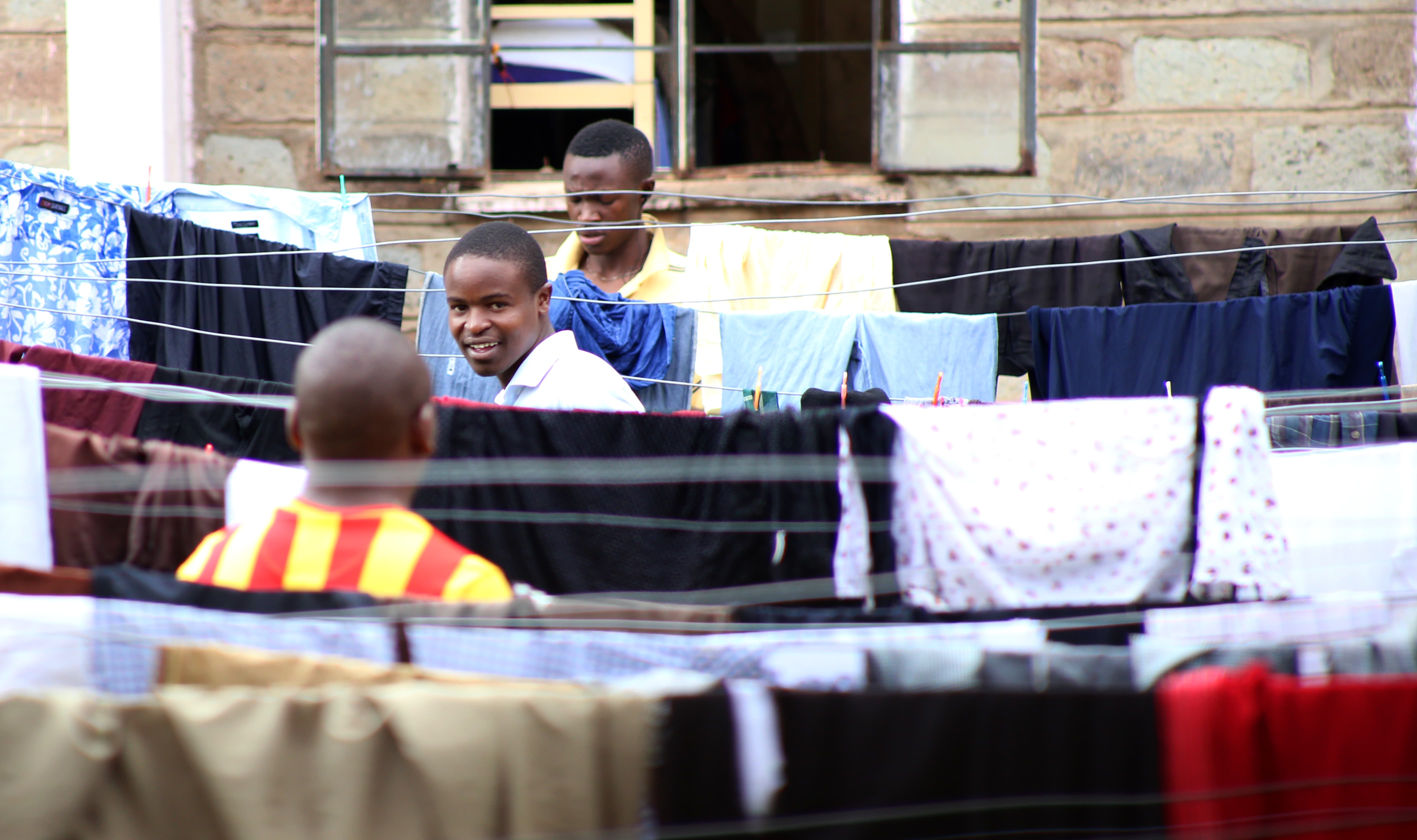 Moi University students do laundry in a scene of daily life. (Billy Mutai/GroundTruth)