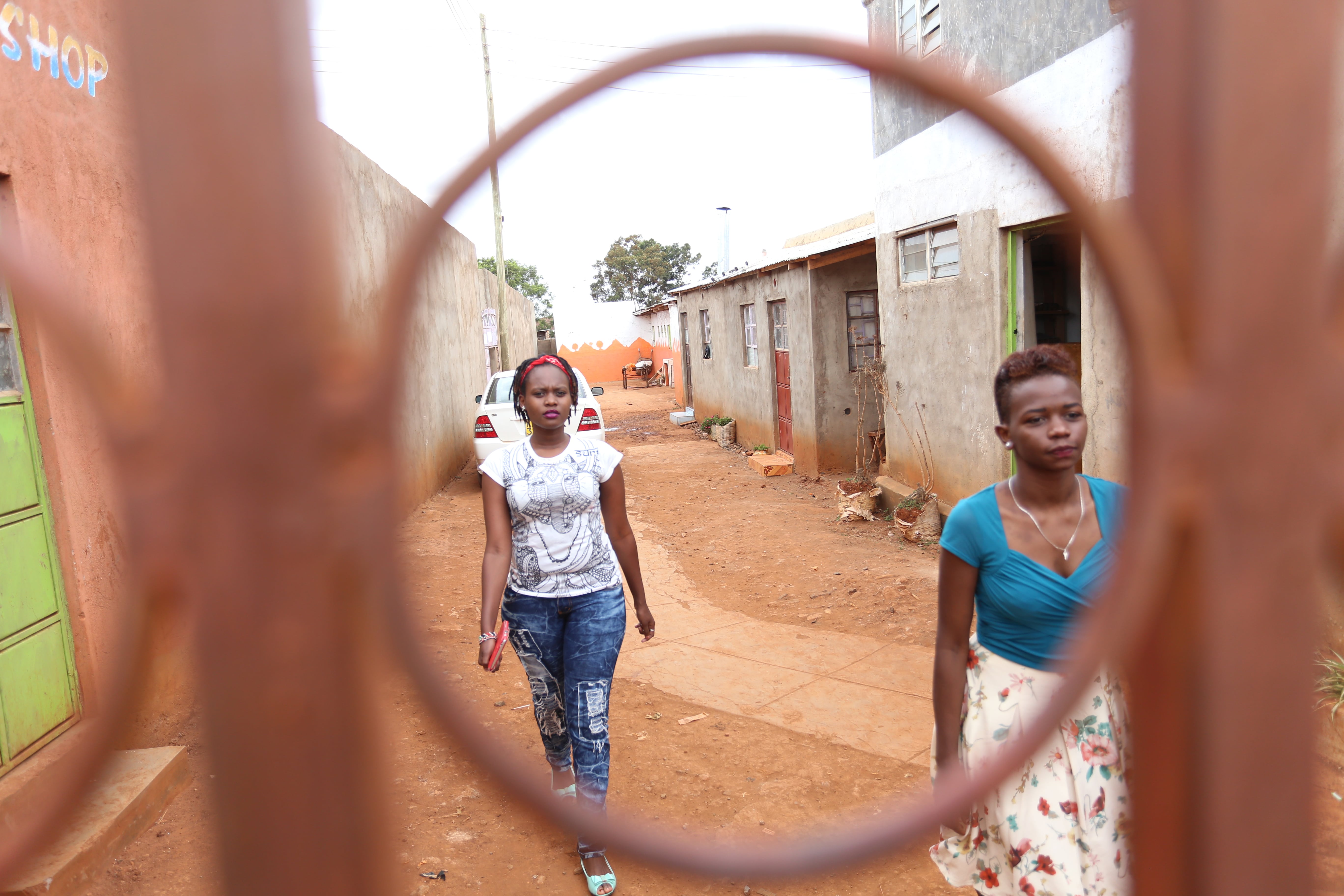 Sandra Gituchu (right) and Maria Njeri at the entrance to their rooms on April 1, 2016. (Billy Mutai/GroundTruth)