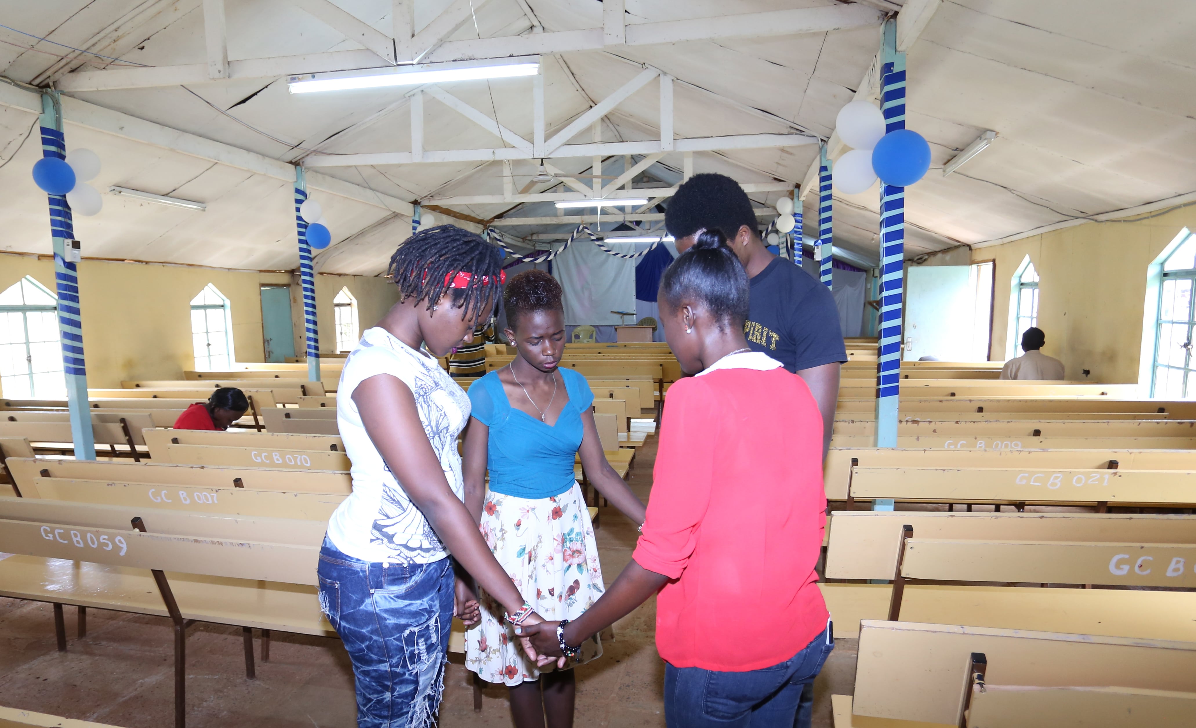 Maria Njeri (left) and Sandra Gituchu (second left) with prayer team members during afternoon fellowship at Moi University Grace Chapel on April 1, 2016. (Billy Mutai/GroundTruth)