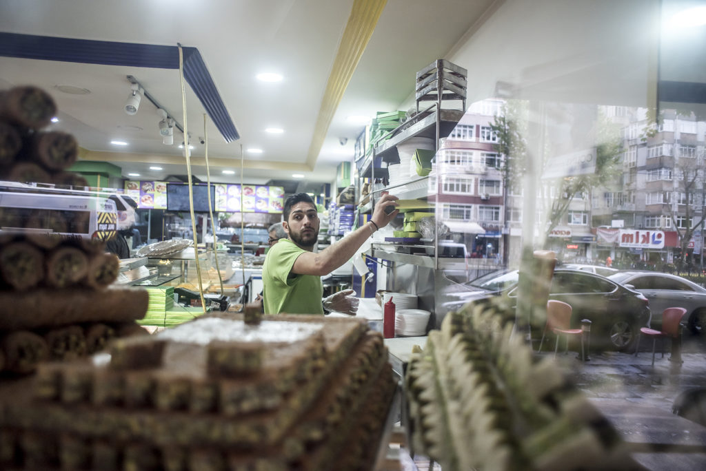 Some of Salloura's signature sweets are visible through the shop window. (Photo by Joris van Gennip/GroundTruth)