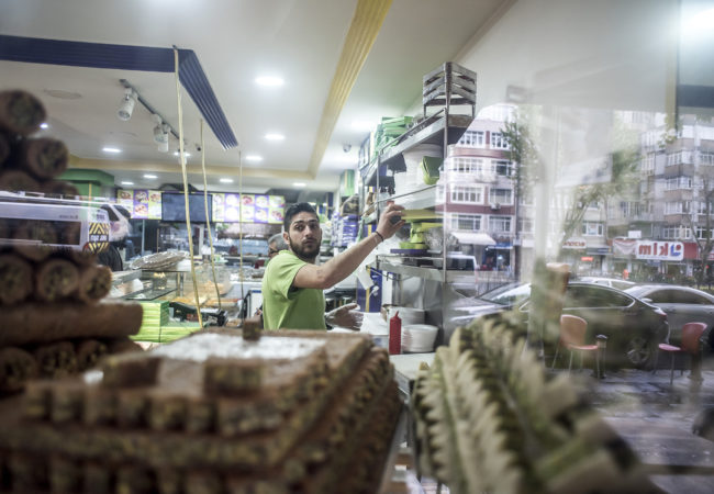 Some of Salloura's signature sweets are visible through the shop window. (Photo by Joris van Gennip/GroundTruth)