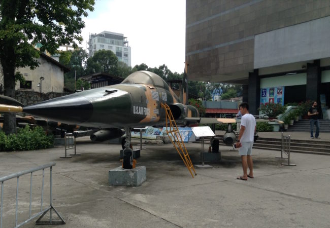 Downed U.S. military helicopters, fighter jets and tanks are on display in front of the War Remnants Museum in Ho Chi Minh City. (Photo by Joanne Silberner/GroundTruth)