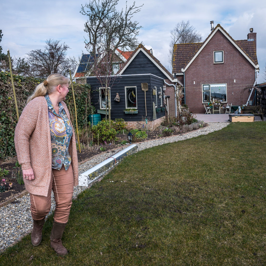 Anneke van Lelieveld's house sits atop a dike near a "room for the river" project in Noordwaard, the Netherlands. She understands the need for a new approach to managing water in this new era of climate change, but misses the neighbors that the project displaced. (Joris van Gennip/The GroundTruth Project)