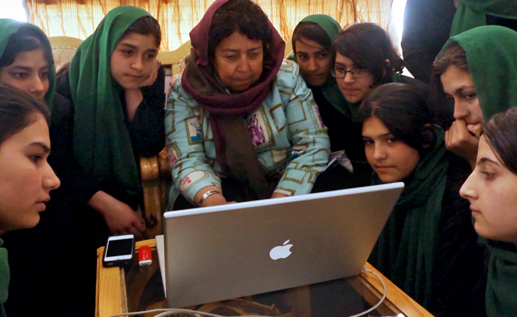 Razia Jan, the founder of a school for Afghan girls, shares photos and stories with the 9th Grade class. (Photo by Beth Murphy/GroundTruth)
