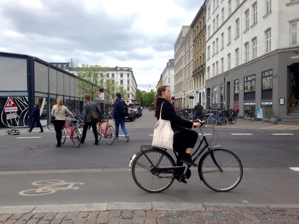 A woman cycles into central Copenhagen. This year, the city ranked first in an index of the world's most bike-friendly cities. (Photo by Charlotte Weiner/GroundTruth)