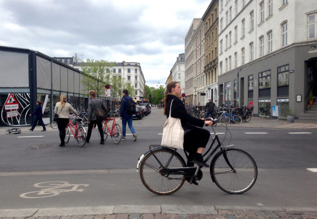 A woman cycles into central Copenhagen. This year, the city ranked first in an index of the world's most bike-friendly cities. (Photo by Charlotte Weiner/GroundTruth)