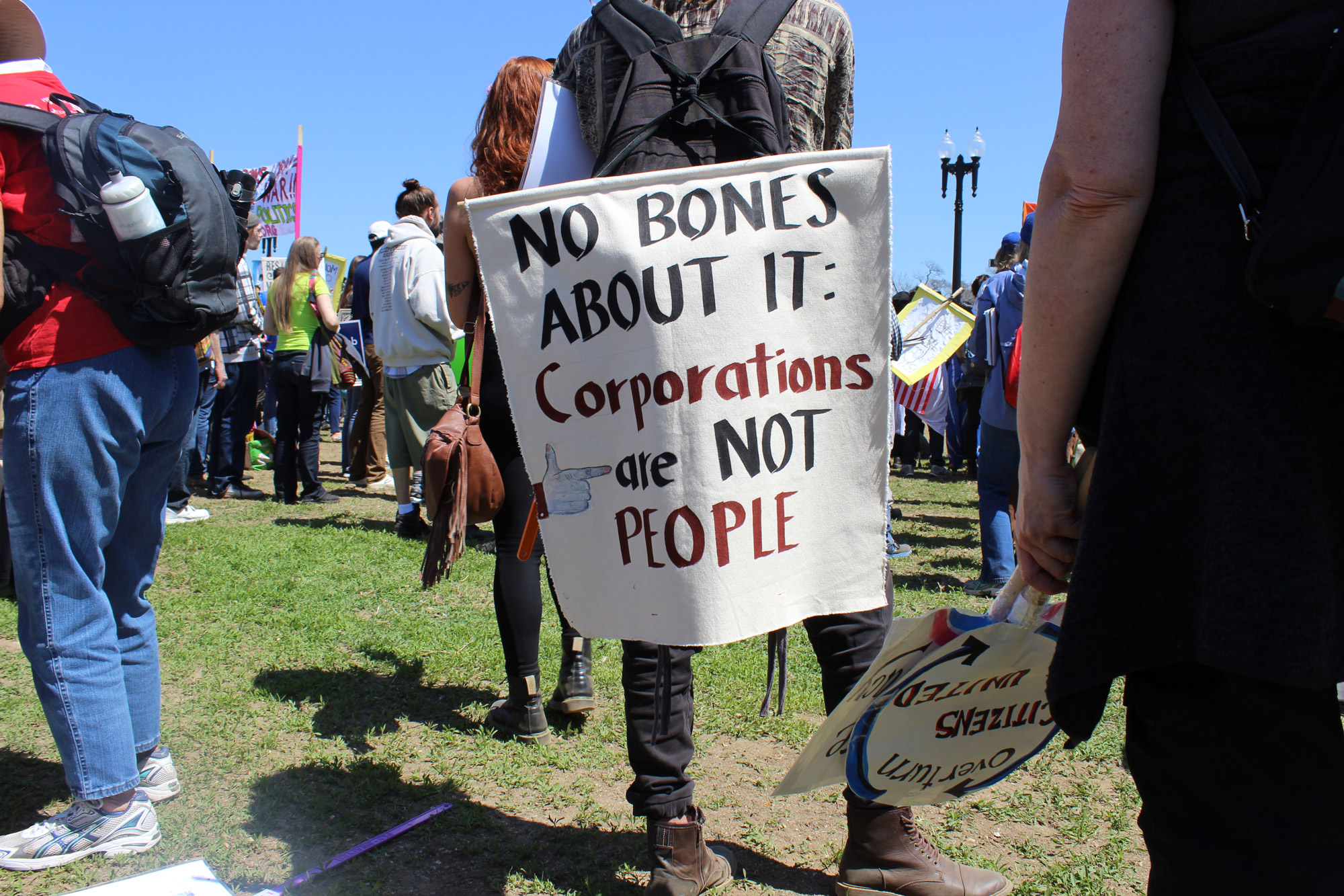 A protestor holds up a sign that says "Corporations are not people" at the three-day Democracy Awakening demonstration in Washington, D.C. (Photo by Carson McGrath/GroundTruth)