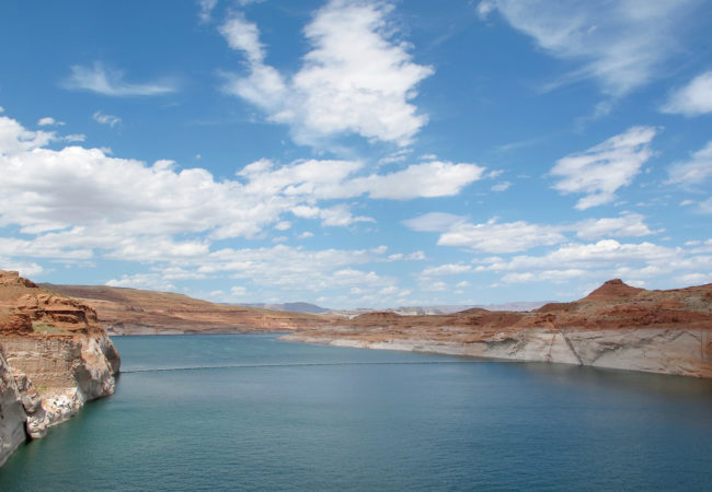 A nearly 100-foot high white-bleached “bathtub ring” marks where the water once rose at Lake Powell. (Photo by Charlotte Weiner/GroundTruth)