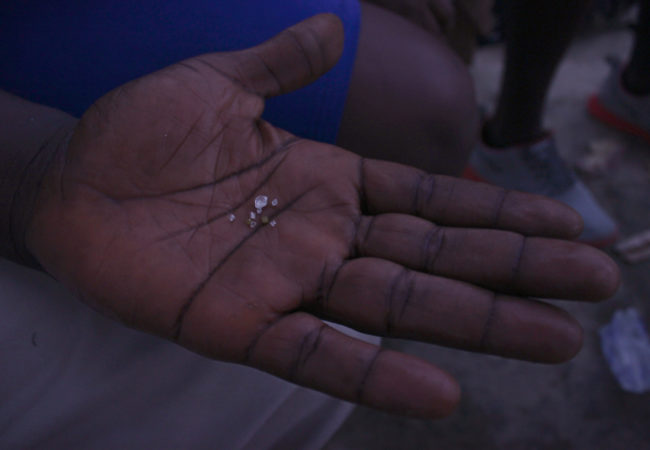 An artisanal miner in Koidu shows off diamonds. He hopes to sell them to one of the town's many dealers.