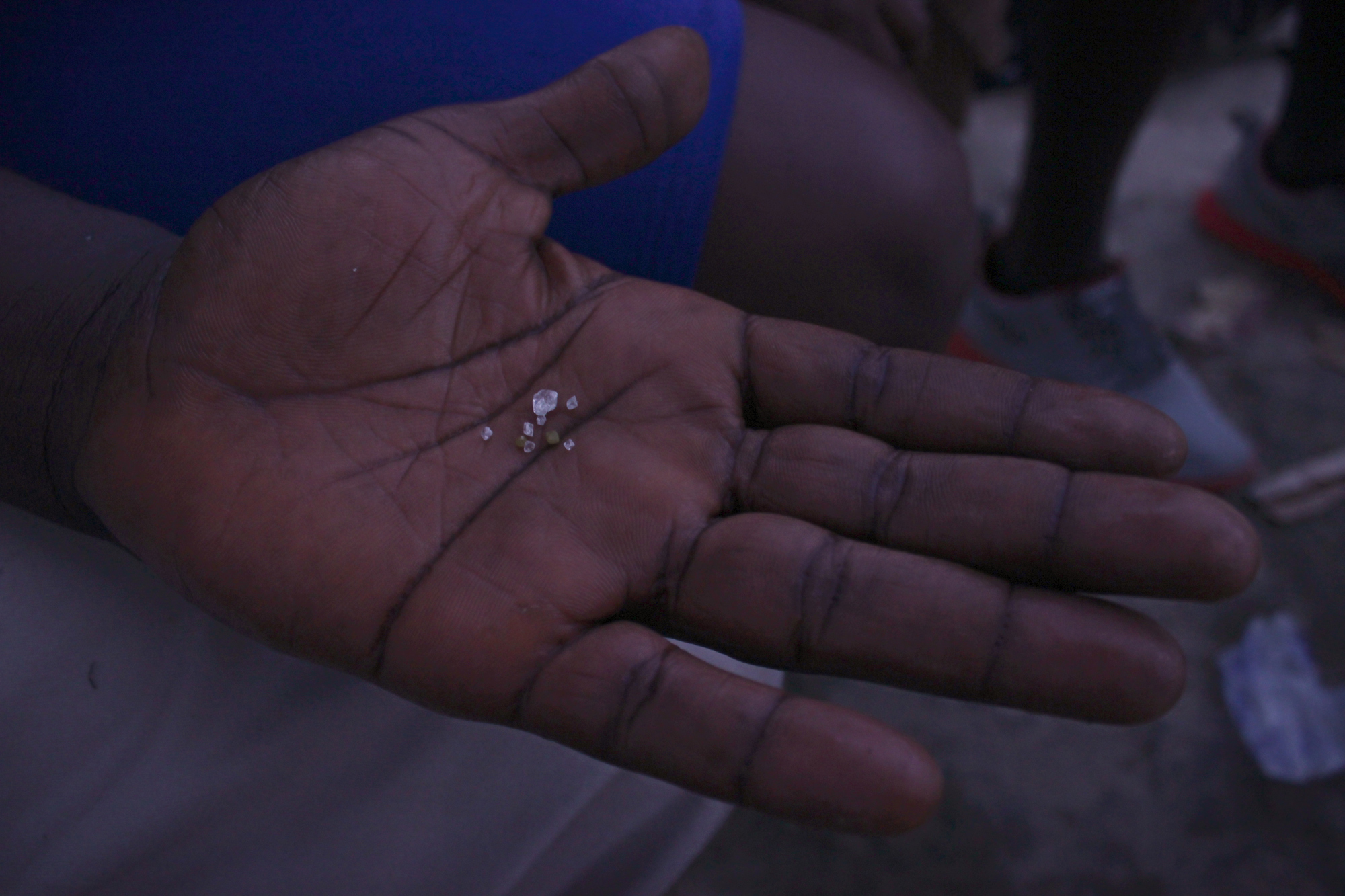 An artisanal miner in Koidu shows off diamonds. He hopes to sell them to one of the town's many dealers.