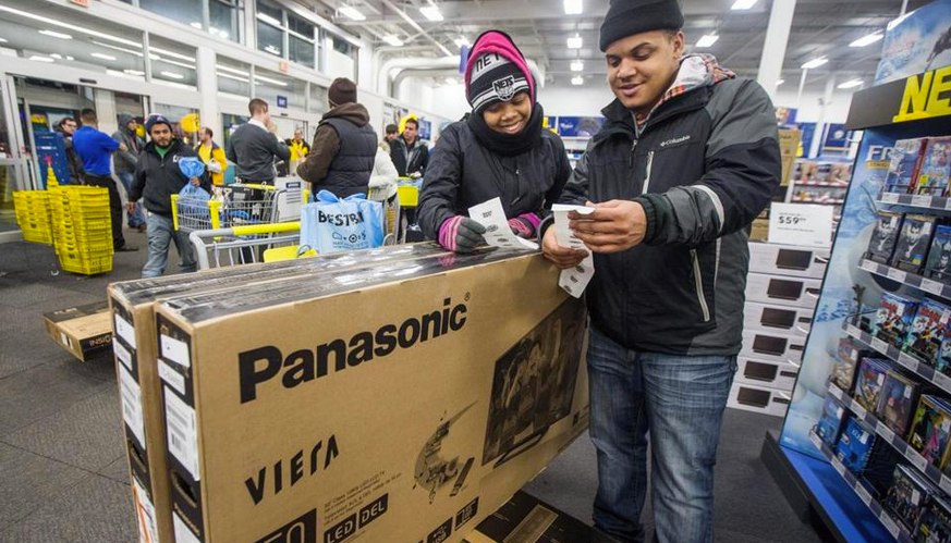 Melvin and Markesha Hernandez bought Panasonic televisions on Black Friday in 2014, then then flipped for a profit. It's one creative way that they've managed to keep their family afloat in hard times. (Photo by Aram Boghosian/Boston Globe)