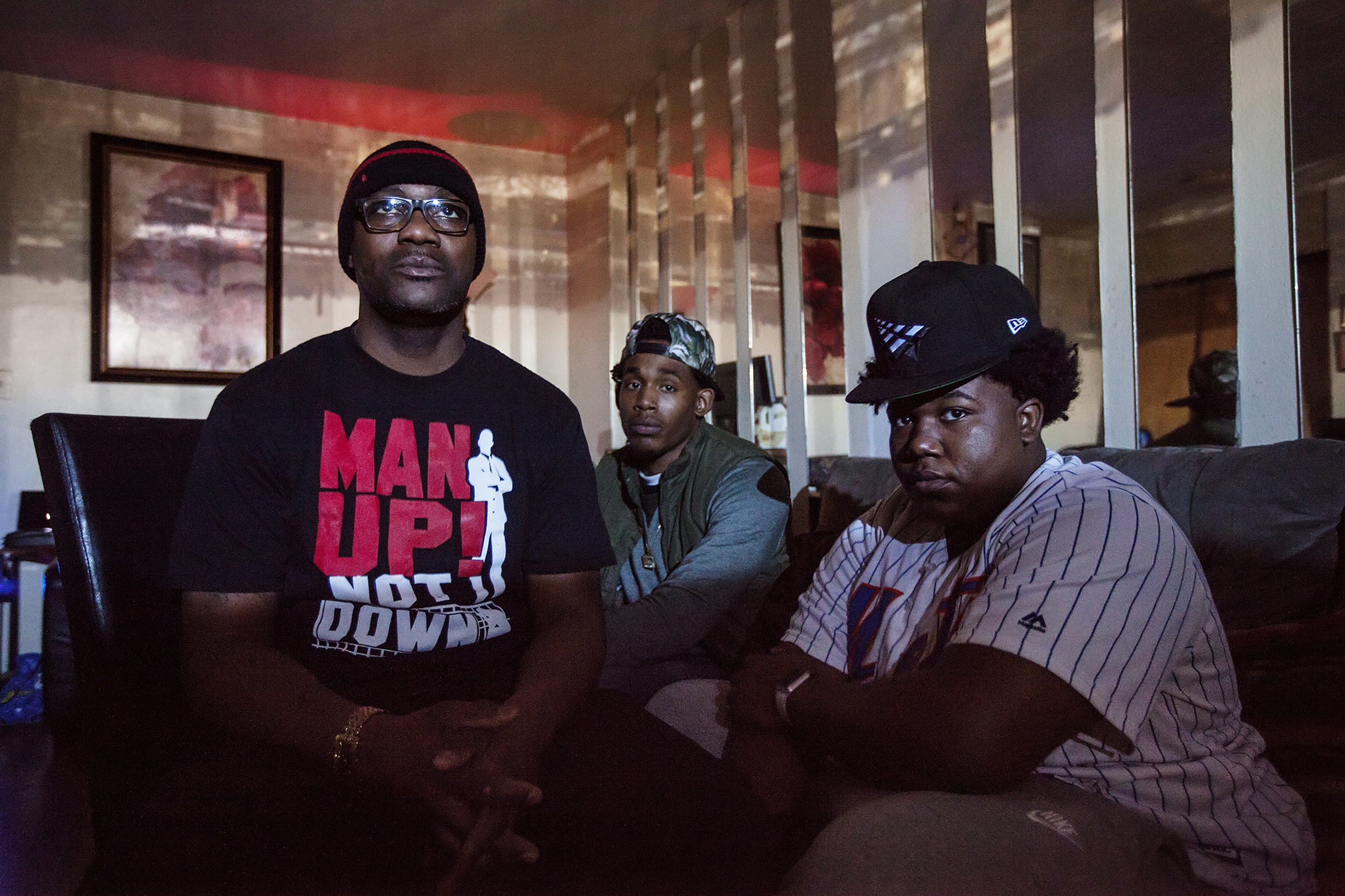 "Brother Kenny" Watson, 49, poses for a portrait with his step children, Sammie Lee Brown Jr. (center) and Justin Grant (right), in East New York, NY on Feb. 7, 2016. "One of the challenges I have is that I am fearful for my son that lives in Atlanta. It's a hard adjustment. You have a family here but you also have a son who needs you there. How do you split yourself?Ó