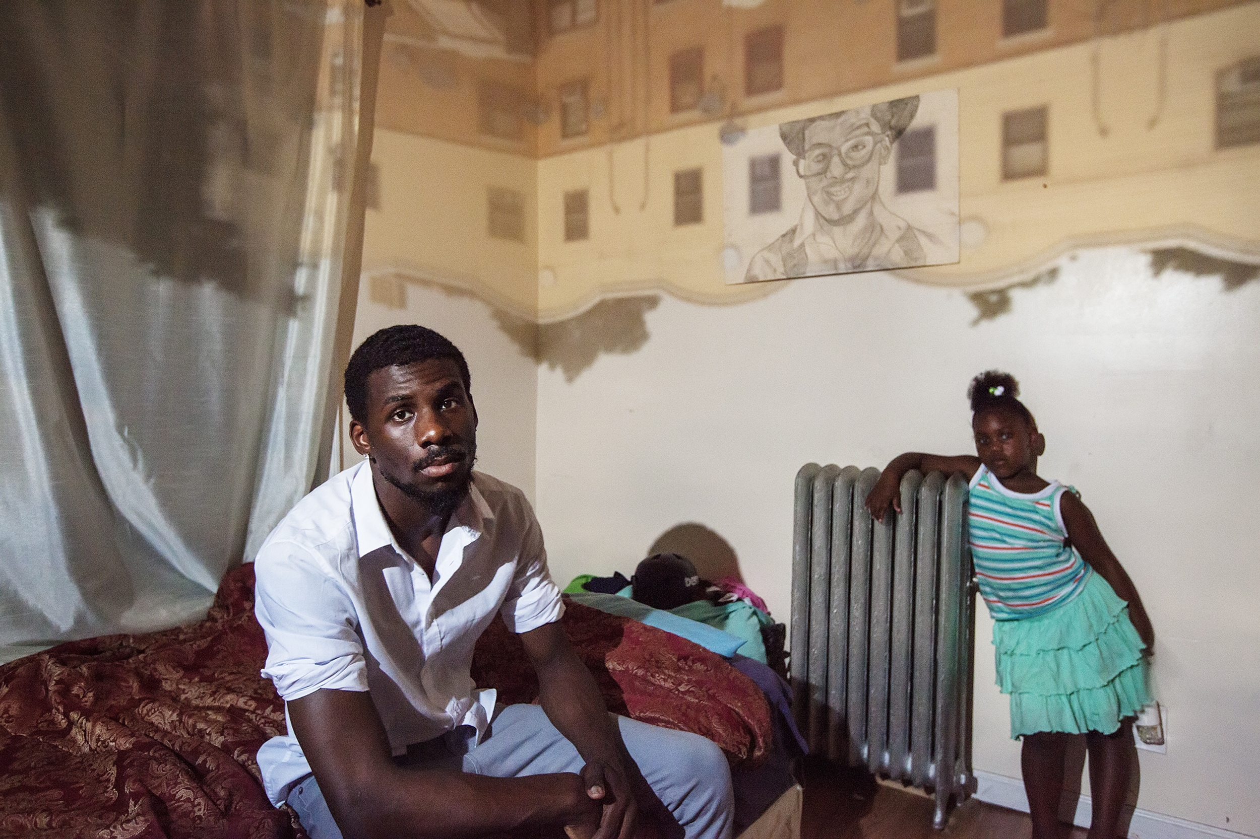 Ariel "AJ" Jones, 25, poses for a portrait with his daughter, Lexi Preston, in East New York, NY on July 12, 2015.