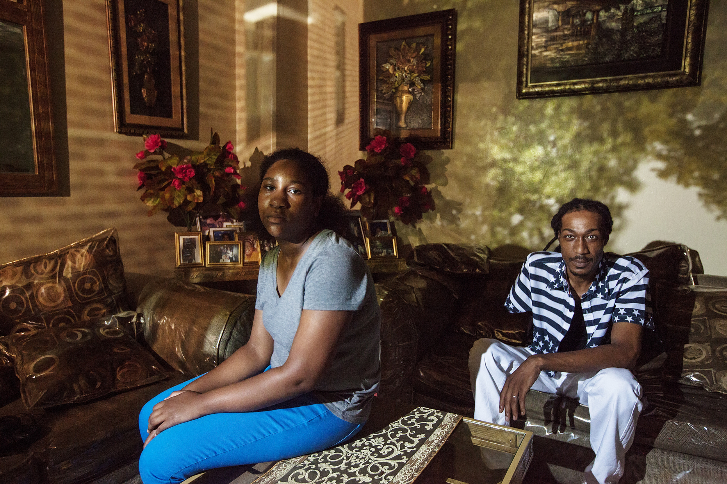 Jason "Law" Woods, 42, poses for a portrait with his daughter, Nevoeh West-Woods, in East New York, NY on July 28, 2015. "The courts do work for men but a lot of men won't pursue that. 'Cause it's been throughout time that you go to court for your child and nine times out of ten, they gonna give it back to the woman. It's like: why fight?" Raising East New York (RENY) is a portraiture project about Black fathers where the photographer Phyllis B. Dooney uses a photographic technique called Camera Obscura to project the outside streets in the subjects apartment in real time.