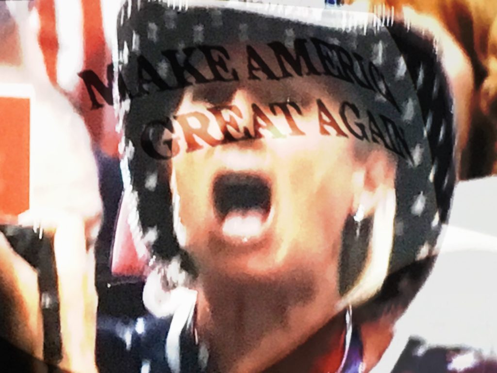 An attendee watches the speeches at the RNC. (Composite image by Biz Herman/GroundTruth)