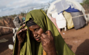A woman dries her clothing on bushes after doing her washing in a rare puddle on the road in one of the drought stricken areas of northwestern Somalia in April 2016. Several successive poor rainy seasons made worse by El Nino conditions in the Horn of Africa hit northern Somalia hard, leaving 1.7 million people in in need of aid, according to the United Nations. (Photo by Nichole Sobecki/GroundTruth)