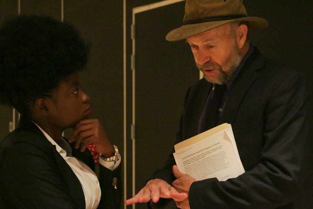 Adenine Akinsemolu, an assistant professor at Obafemi Awolowo University talks with climatologist and Columbia professor James Hansen. The two professors have both taken steps to support youth combating climate change. (Photo by Justine Calma/GroundTruth)