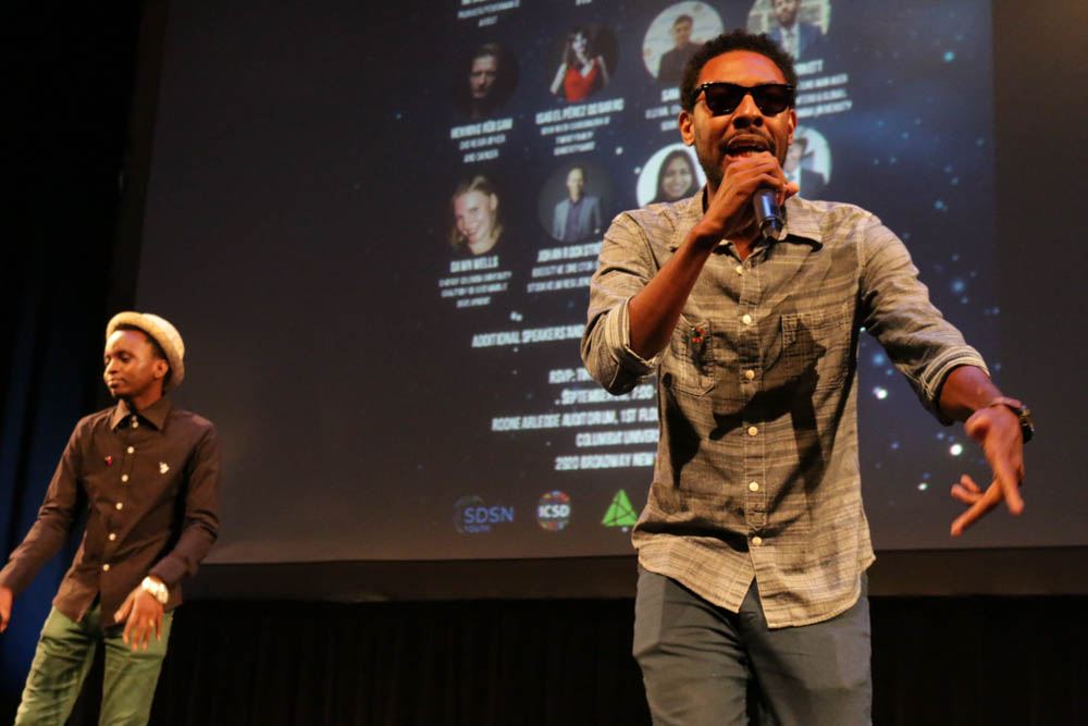 William Otuck, 27, (left) from Tanzania and Trevor Arnett, 31, (right) perform at the youth-hosted event, Reimagining 2030. Young people at the event sang, danced and rapped about the kind of future they envision after the Sustainable Development Goals are reached. (Photo by Justine Calma/GroundTruth)