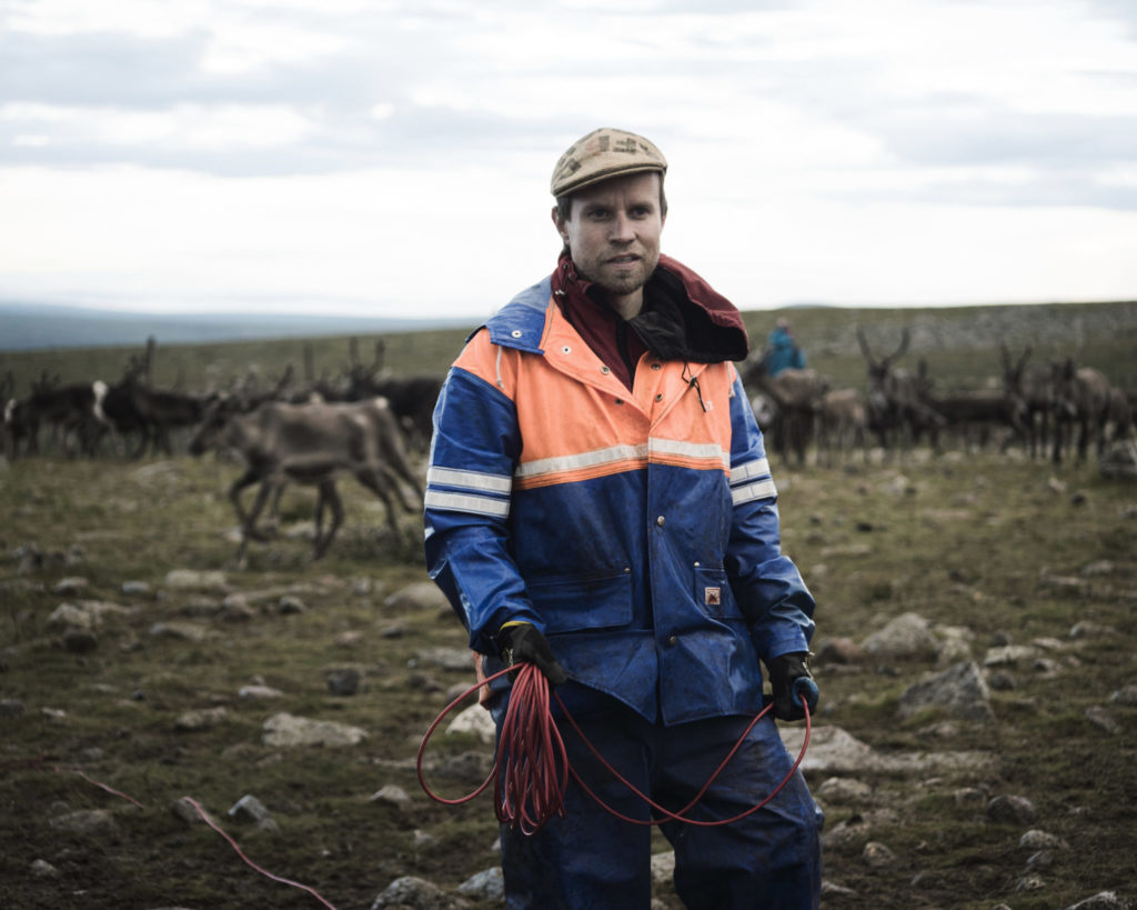 Simon Issát Marainen herds reindeer with his family outside of Nedre Soppero, Sweden. (Photo by Camilla Andersen/GroundTruth)