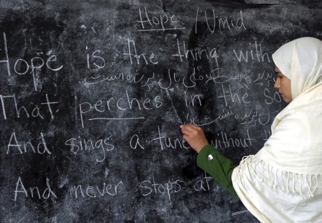 A student writes on the blackboard at the Zabuli School in Deh-Subz, Afghanistan. (Beth Murphy/GroundTruth Films)