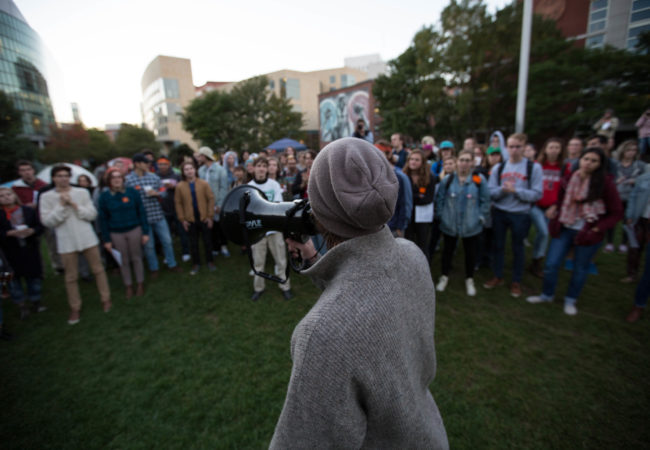 Surrounded by a crowd, a Northeastern University student advocated for divestment from fossil fuels on campus on the evening of Tuesday, Oct. 4, 2015. (Photo by Alastair Pike/GroundTruth)