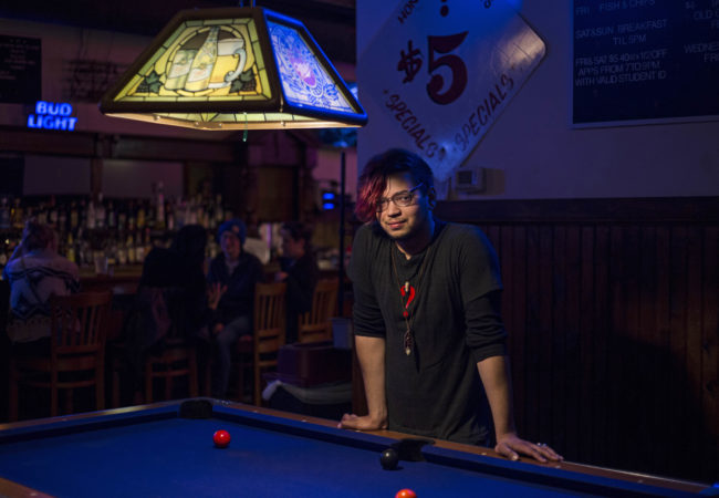 Jody Ebejer, 22, a native of Detroit, poses at his workplace Honest John's in Midtown, on October, 24, 2016. Ebejer is now voting for independent candidate Jill Stein. "People tell me that its really unrealistic, like don't throw your vote away, but I'm like, it's only throwing my vote away if I'm vote for someone who I don't agree with, who I don't feel represents me and my interest," Ebejer said. (Photo by Brittany Greeson/GroundTruth)