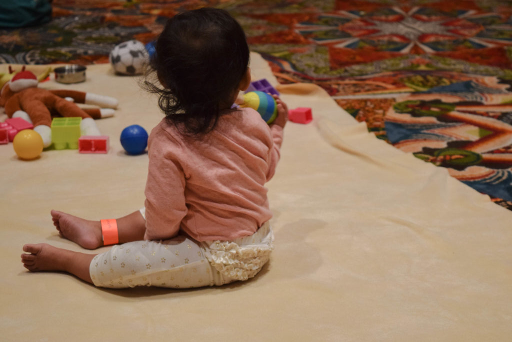 A young child plays under the supervision of childcare workers at the Grace Hopper Celebration of Women in Computing, a renown tech conference. (Photo by Alicia Miles/GroundTruth)