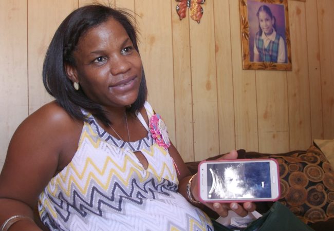 Dahiana Santana shows a sonogram of the baby she's carrying. She worries she might have contracted Zika during her pregnancy, but she never received her test results. (GroundTruth Films)