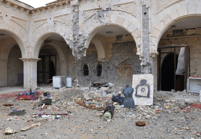 The destroyed courtyard of Qaraqoosh's Al-Taheera church, the largest in Iraq and one of the biggest in the Middle East. ISIS transformed the grounds into a shooting range with mannequins from a nearby clothing shop. (Photo by Lauren Bohn/GroundTruth)