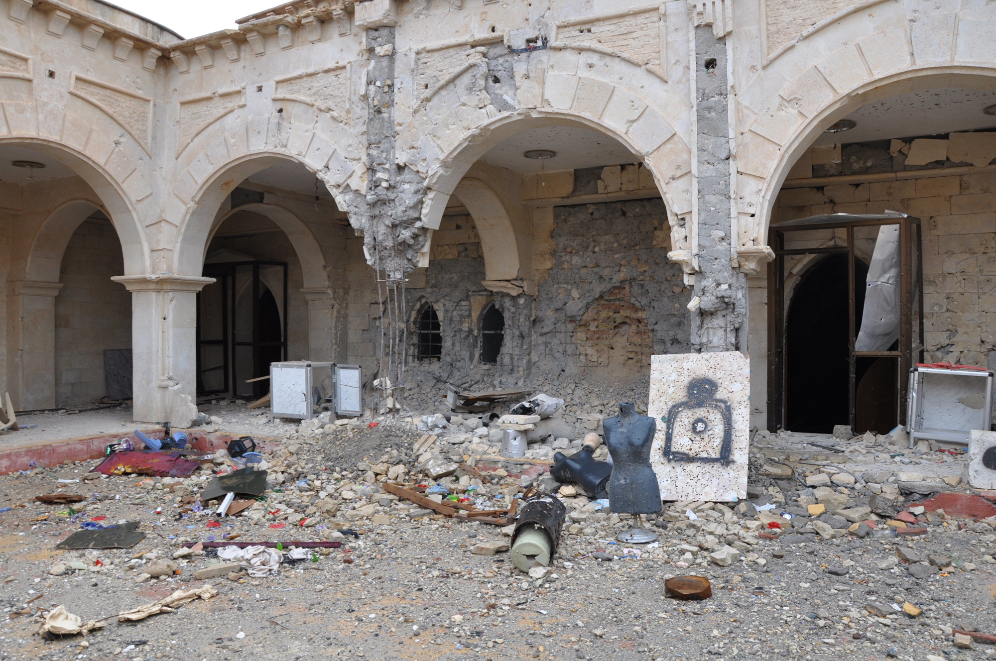 The destroyed courtyard of Qaraqoosh's Al-Taheera church, the largest in Iraq and one of the biggest in the Middle East. ISIS transformed the grounds into a shooting range with mannequins from a nearby clothing shop. (Photo by Lauren Bohn/GroundTruth)