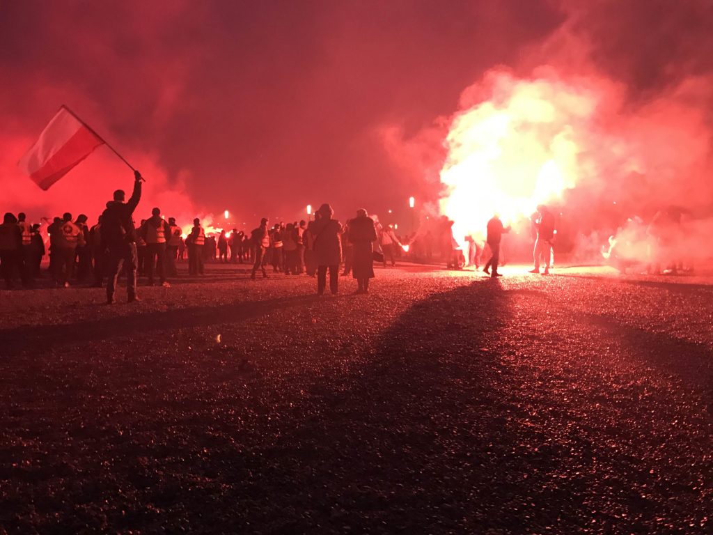 Snow mixed with ash at the nationalist rally in Warsaw on Nov. 11, where many young men wielded flares, flags and lit illegal fireworks. (Photo by Karolina Chorvath/GroundTruth)