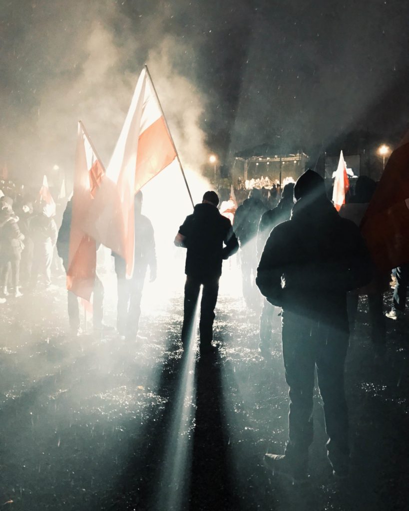 A Polish nationalist demonstrator stands outside of National Stadium in Warsaw at Independence Day rallies in 2016. (Photo by Karolina Chorvath/GroundTruth)