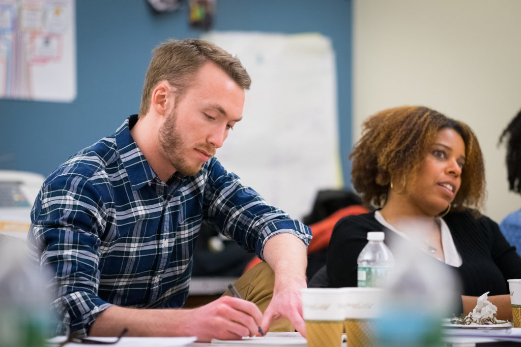 GroundTruth fellow Noah Caldwell (left) takes notes during a session for the health podcast fellowship. (Edwin J. Torres/GroundTruth)