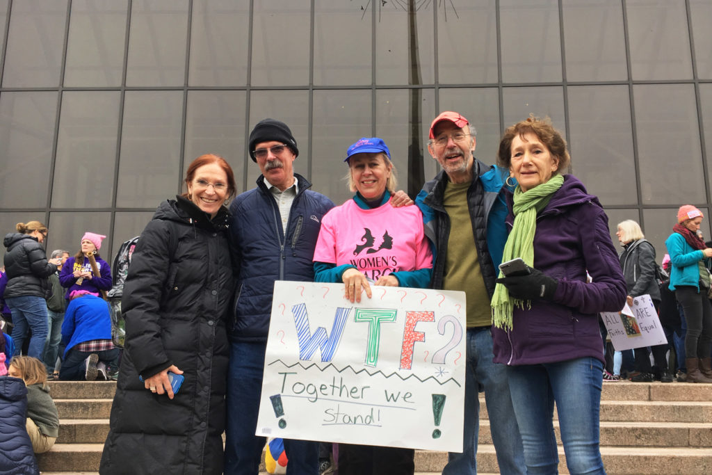Anna Fierst, the great-granddaughter of Eleanor Roosevelt (center), holds up a sign that says, "Together We Stand." (Photo by Beth Murphy/GroundTruth)
