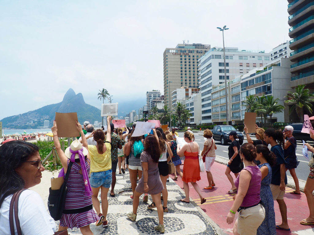 Demonstrators march along the beach during Rio's Women's March. (Photo by Catherine Osborn/GroundTruth)