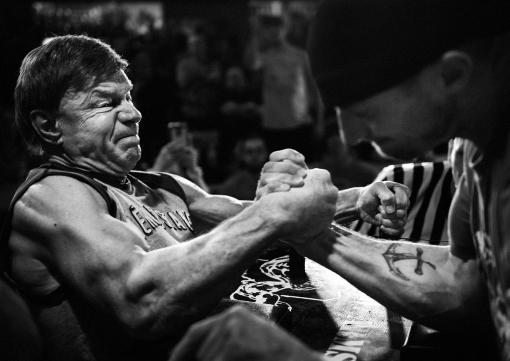 2) Devio pins an opponent in the 2nd round of the Maine State Championship arm wrestling tournament in South Portland, Maine, on March 12, 2016.(Photo by Adam Glanzman/GroundTruth).